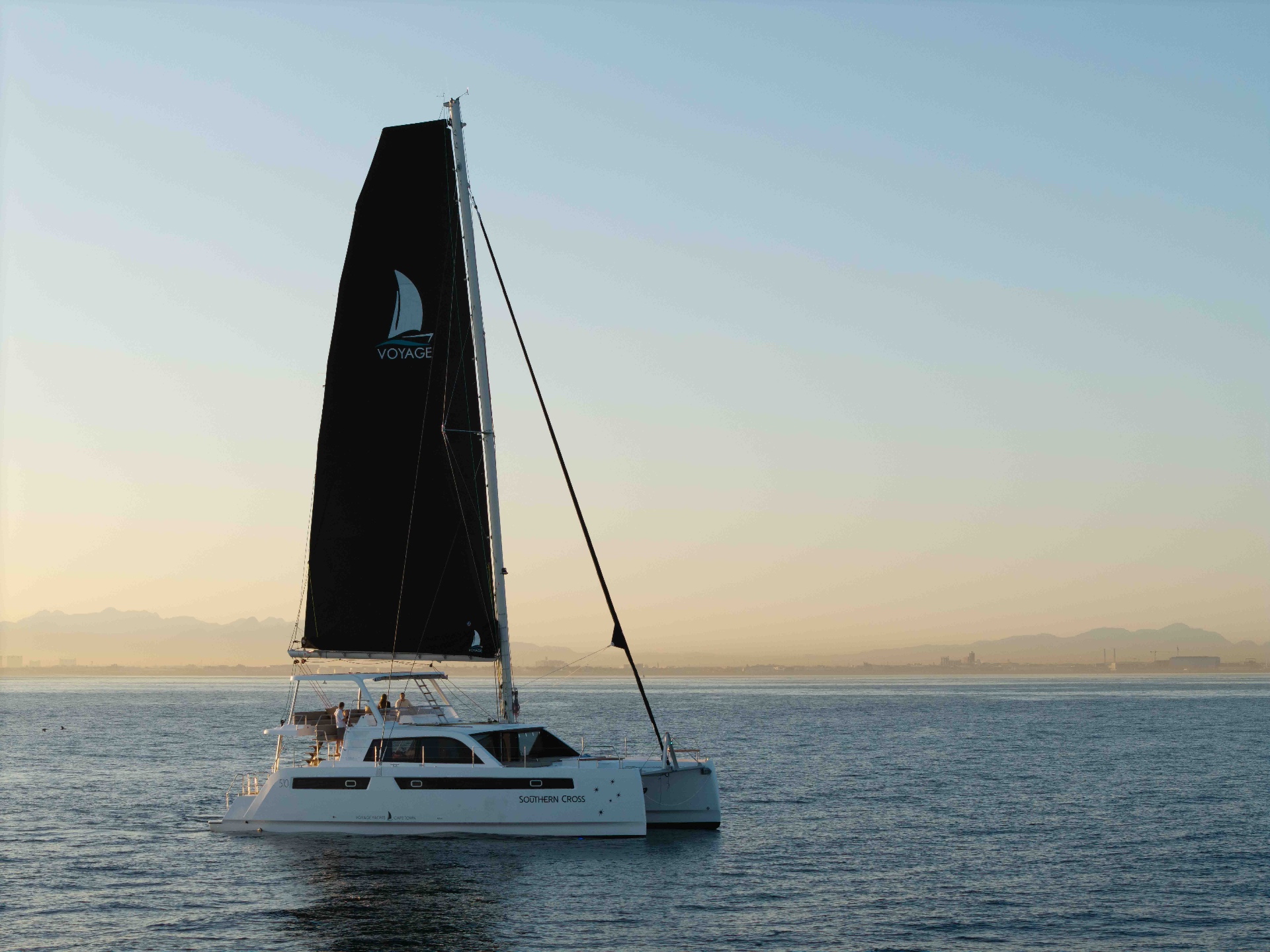 Voyage 510 under sail at sunset