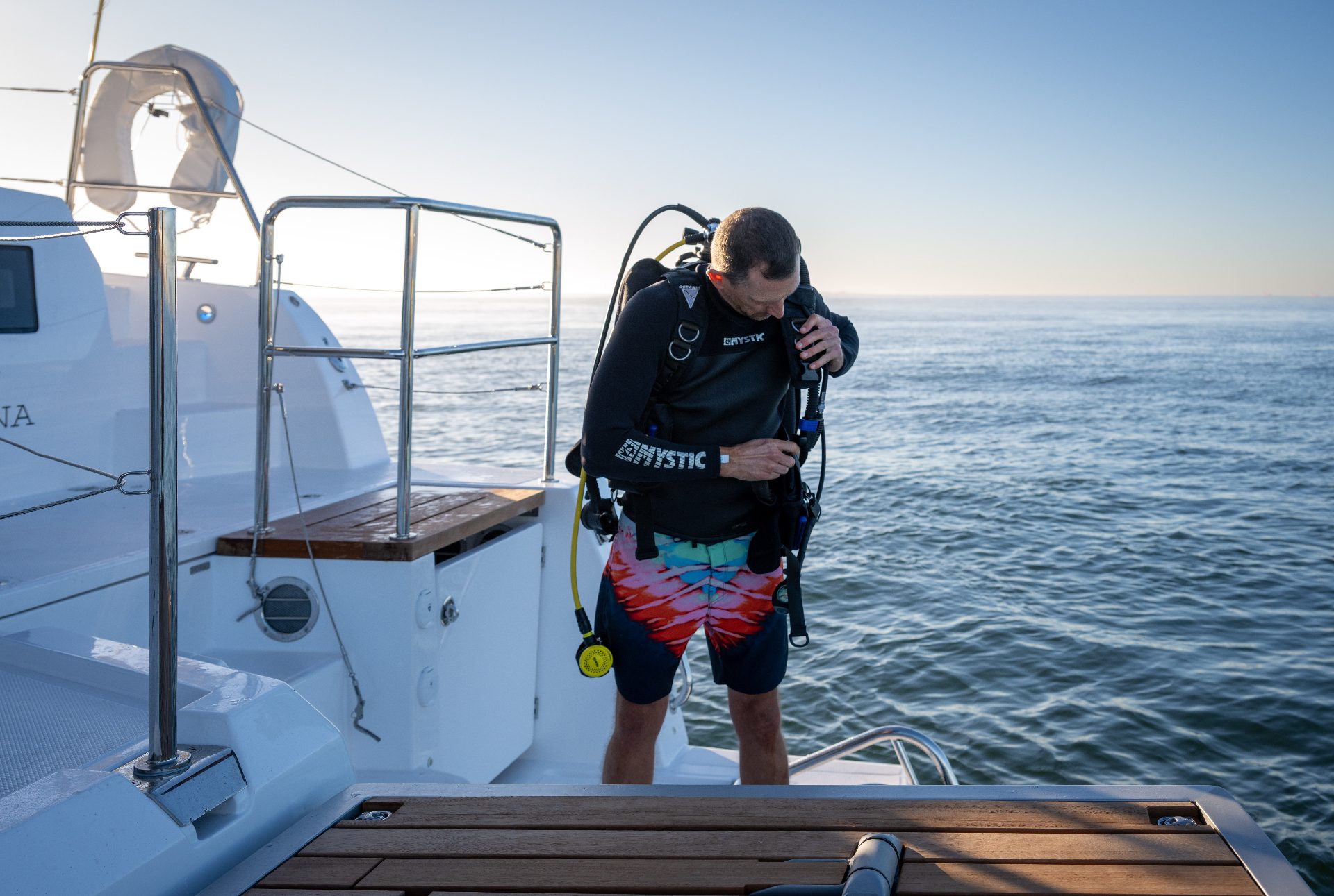 Diver preparing gear on the Voyage 590 swim platform