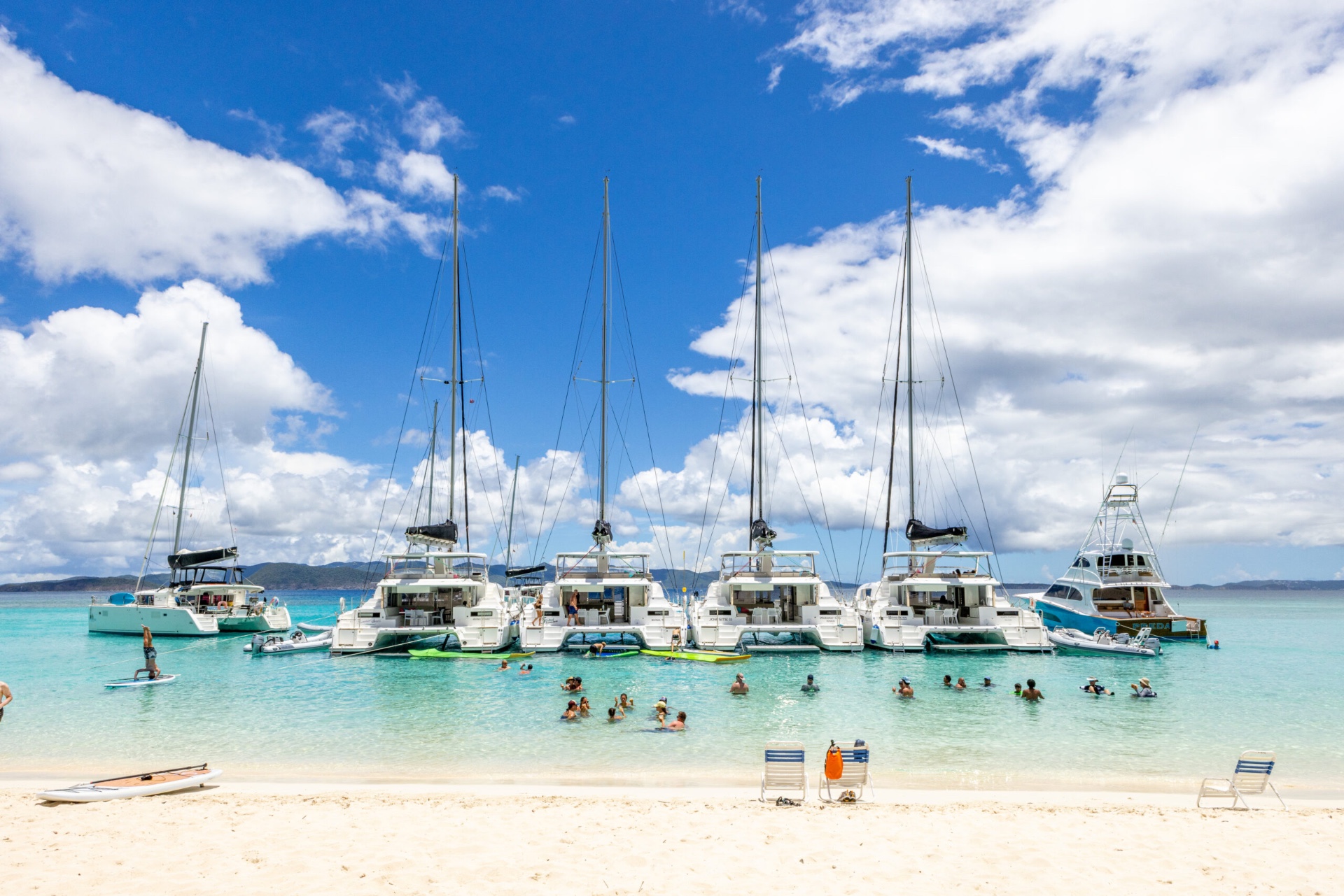 Voyage 590 fleet line-up anchored off a beach